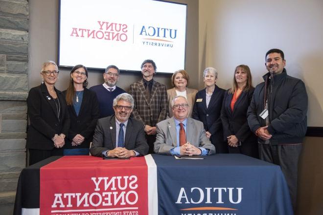 Members of Utica University and SUNY Oneonta join their respective institutional presidents for the signing of an Articulation Agreement.